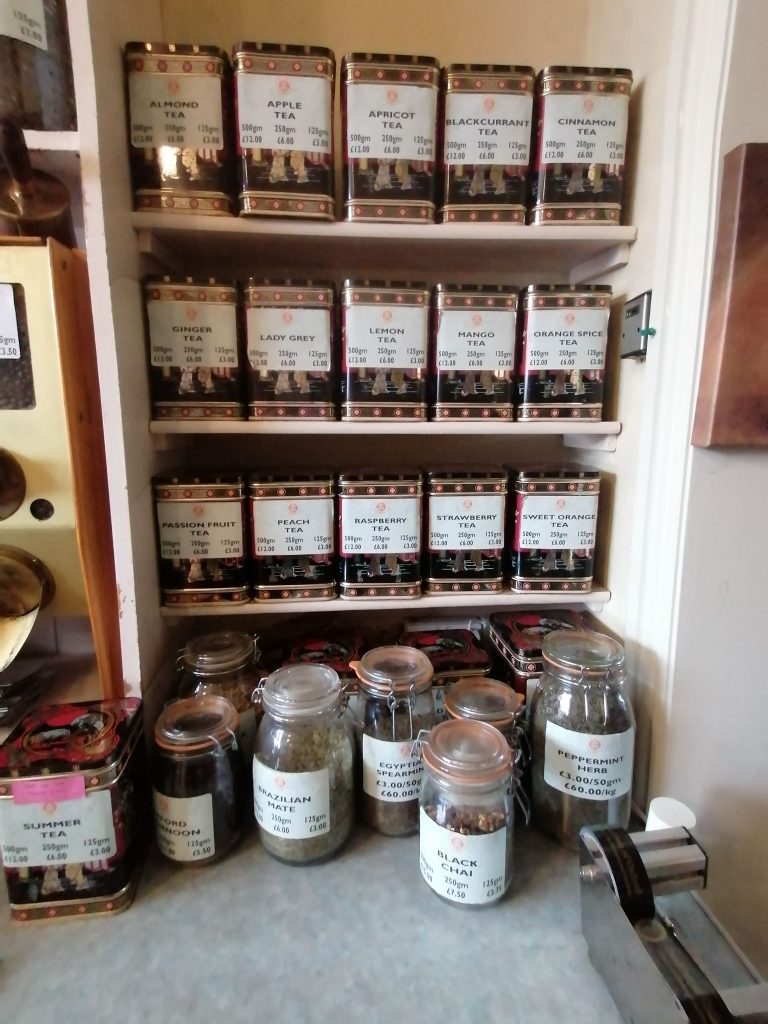 Many different teas and coffees on the shelves