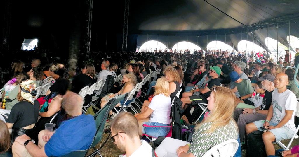 Hundreds of people in a tent at Vegan Camp Out.