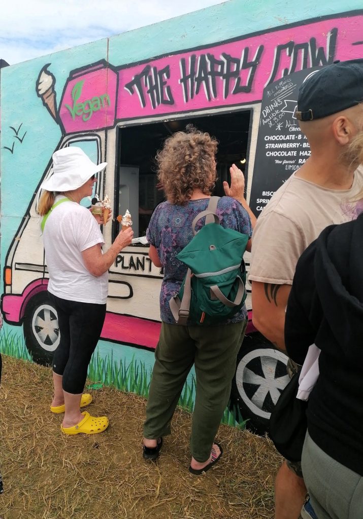 Two ladies order an ice cream from a van.
