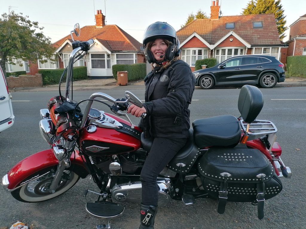 photo of Sarah Becker on a Harley Davidson.