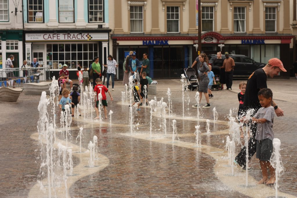 Children play in the fountain at Northampton music featival