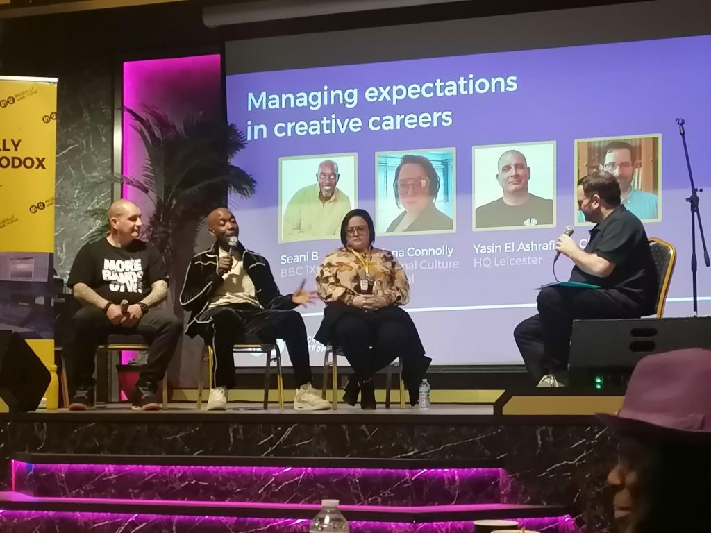 Three people speak about music at Musically Unorthodox. 