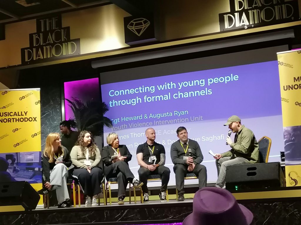 A panel of people speak at a music conference in Northampton. 