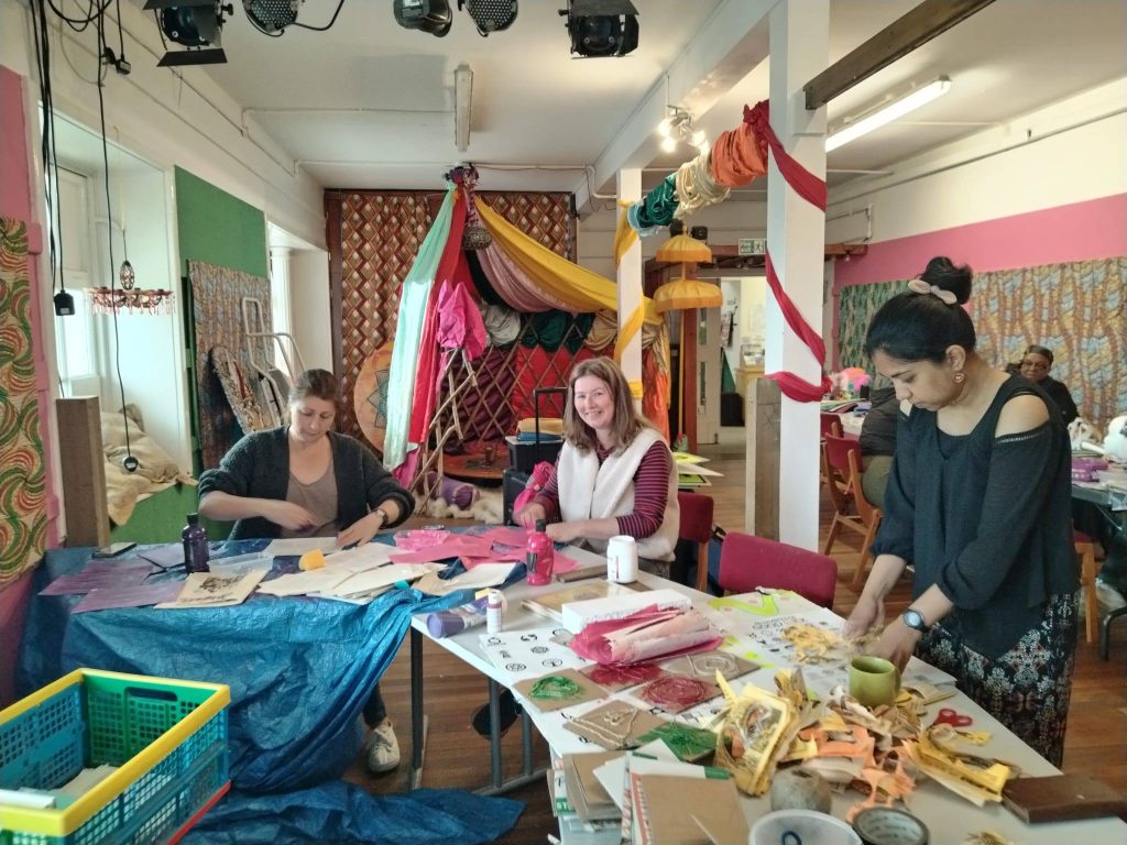 An artist Sarah Becker and a lady create carnival outfits
