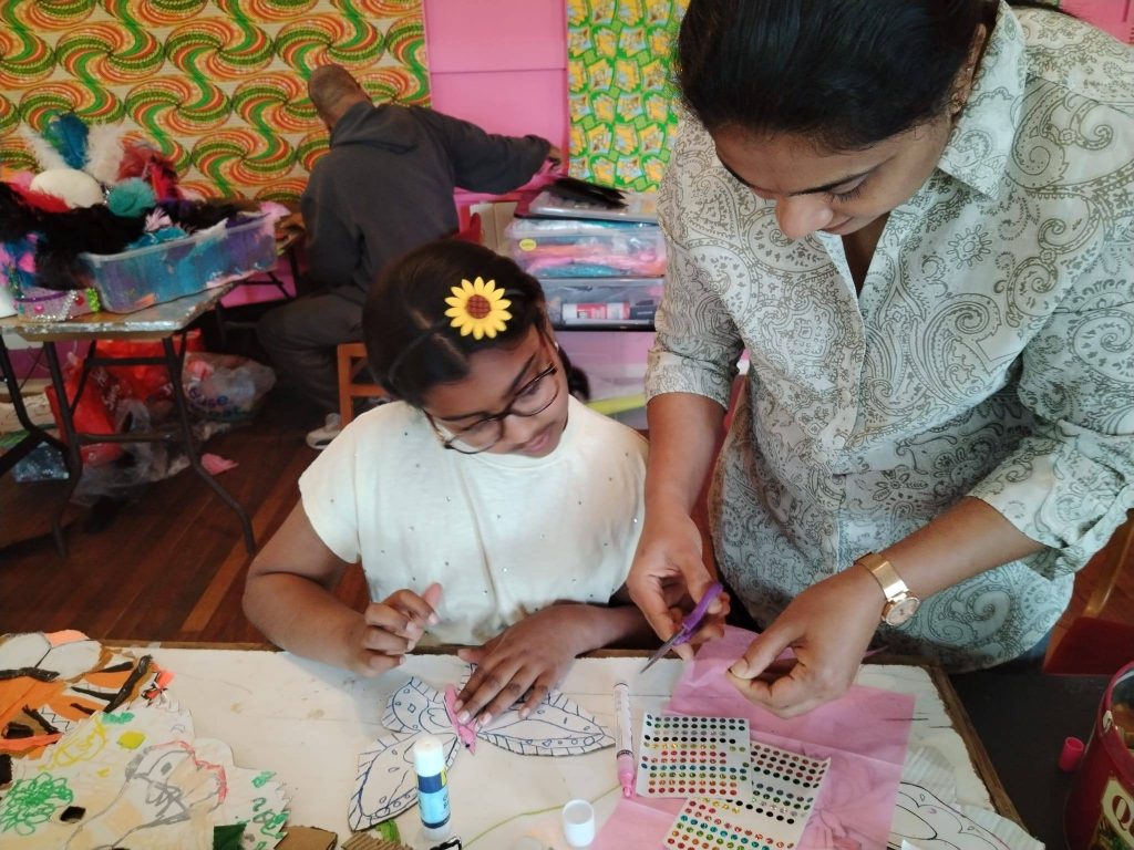 A mother and child create carnival costumers at Northampton Carnival