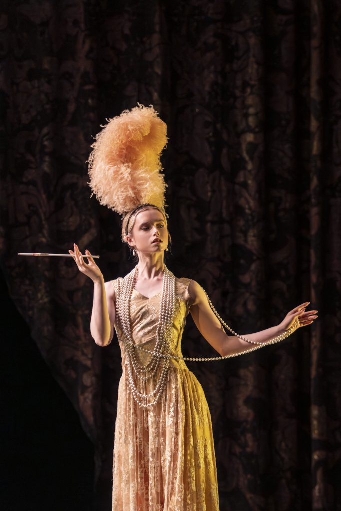 A ballerina dances in a ballet in a yellow sequinned costume