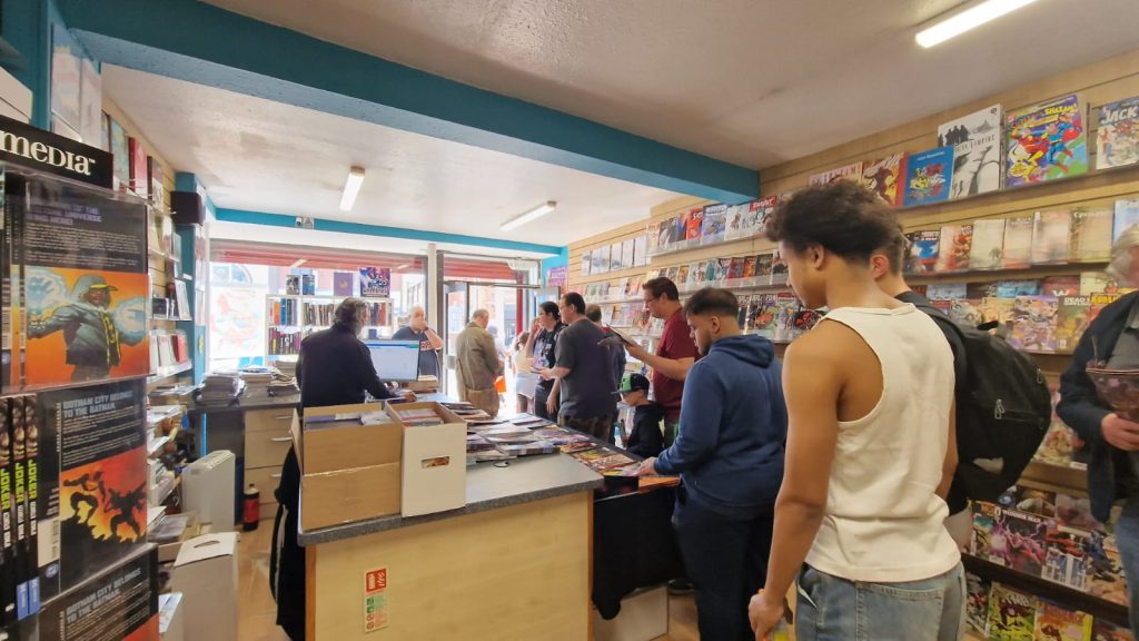 a queue of customers in Close encounters comic shop