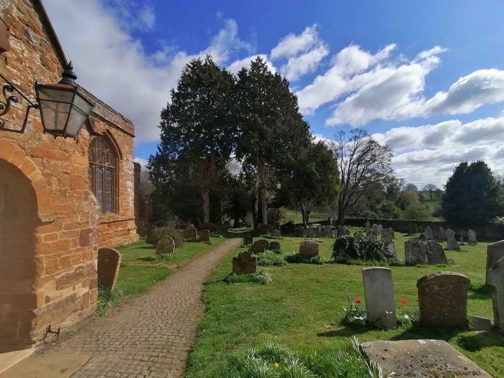 The church surrounded by gravestones. 