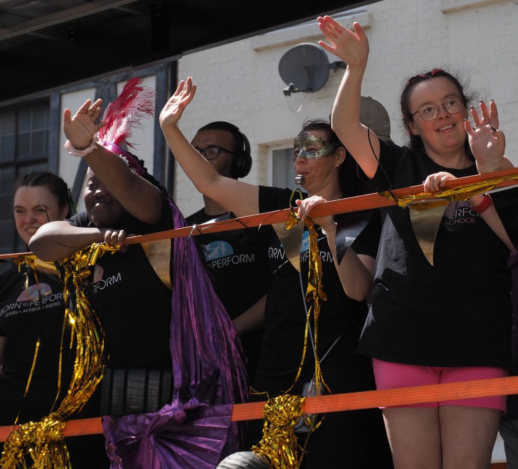 People wavign and smiling at Northampton cArnival 2026