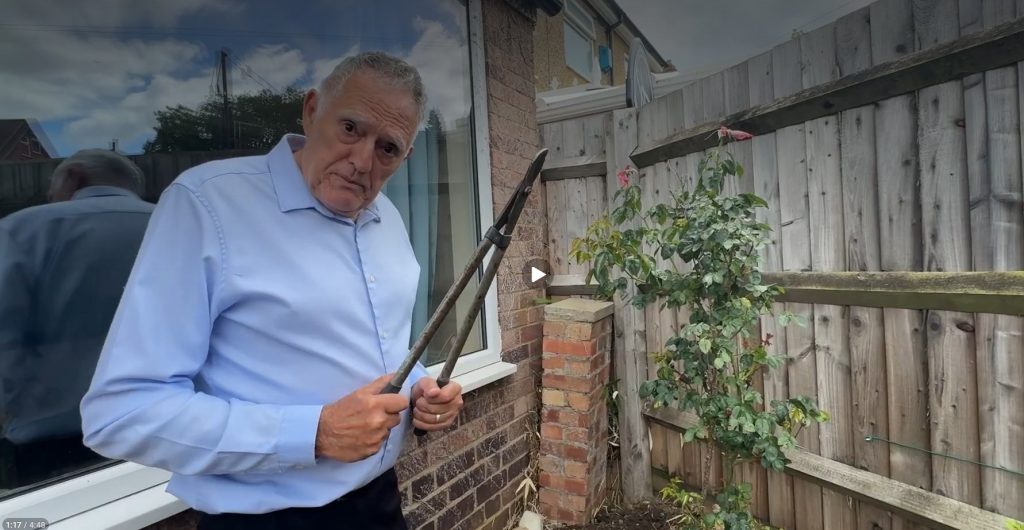 Dennis holds secaters in hand